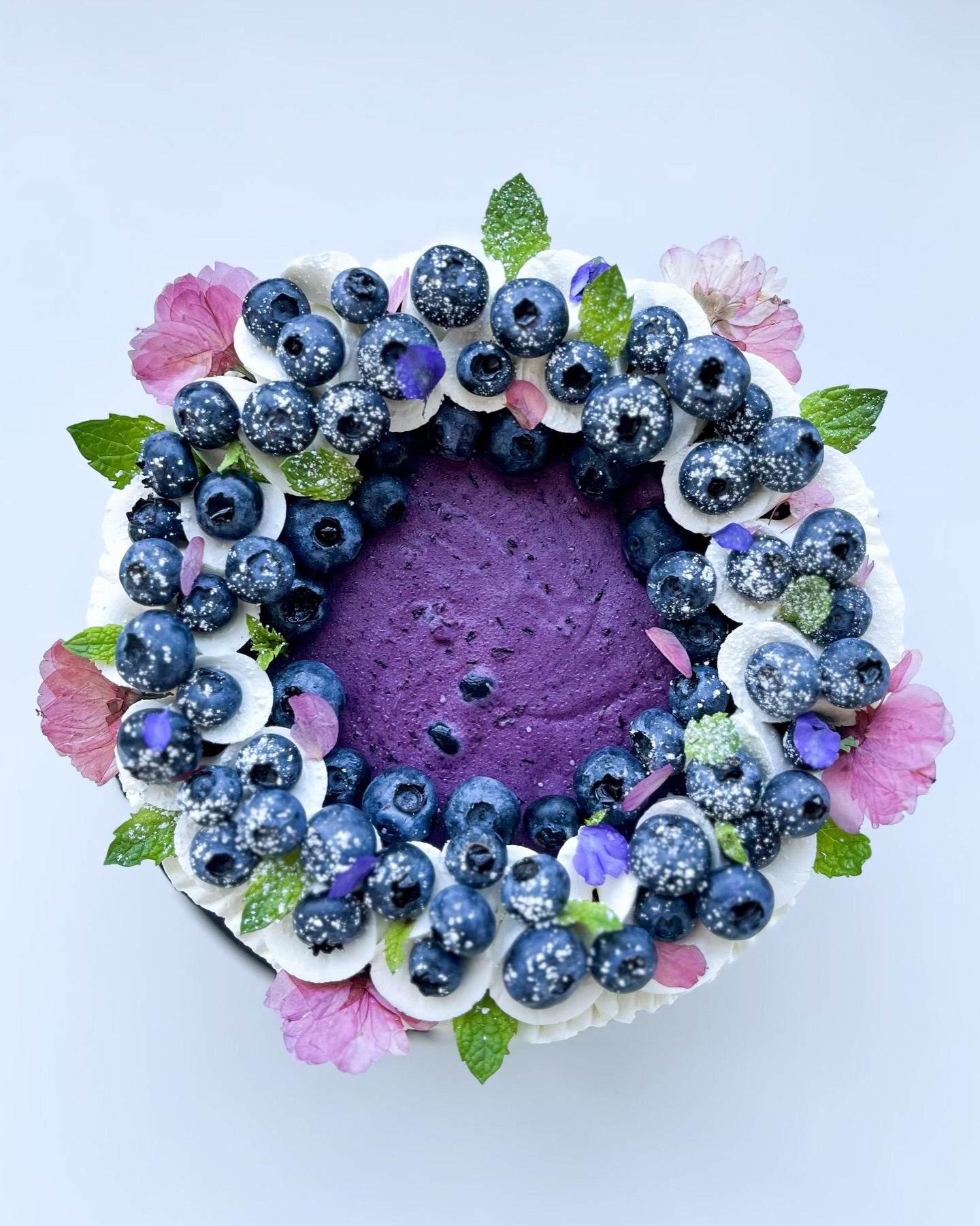 Blueberry top-down cheesecake with edible flowers