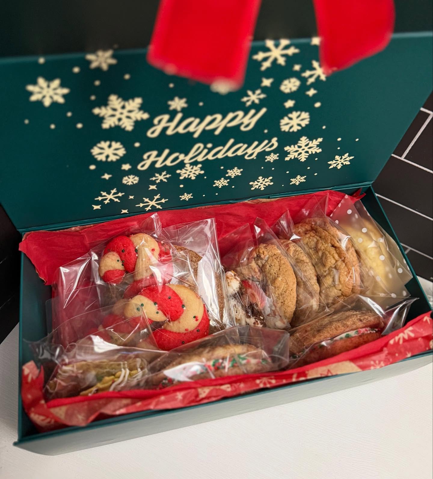 Open holiday cookie box with festive sugar cookies