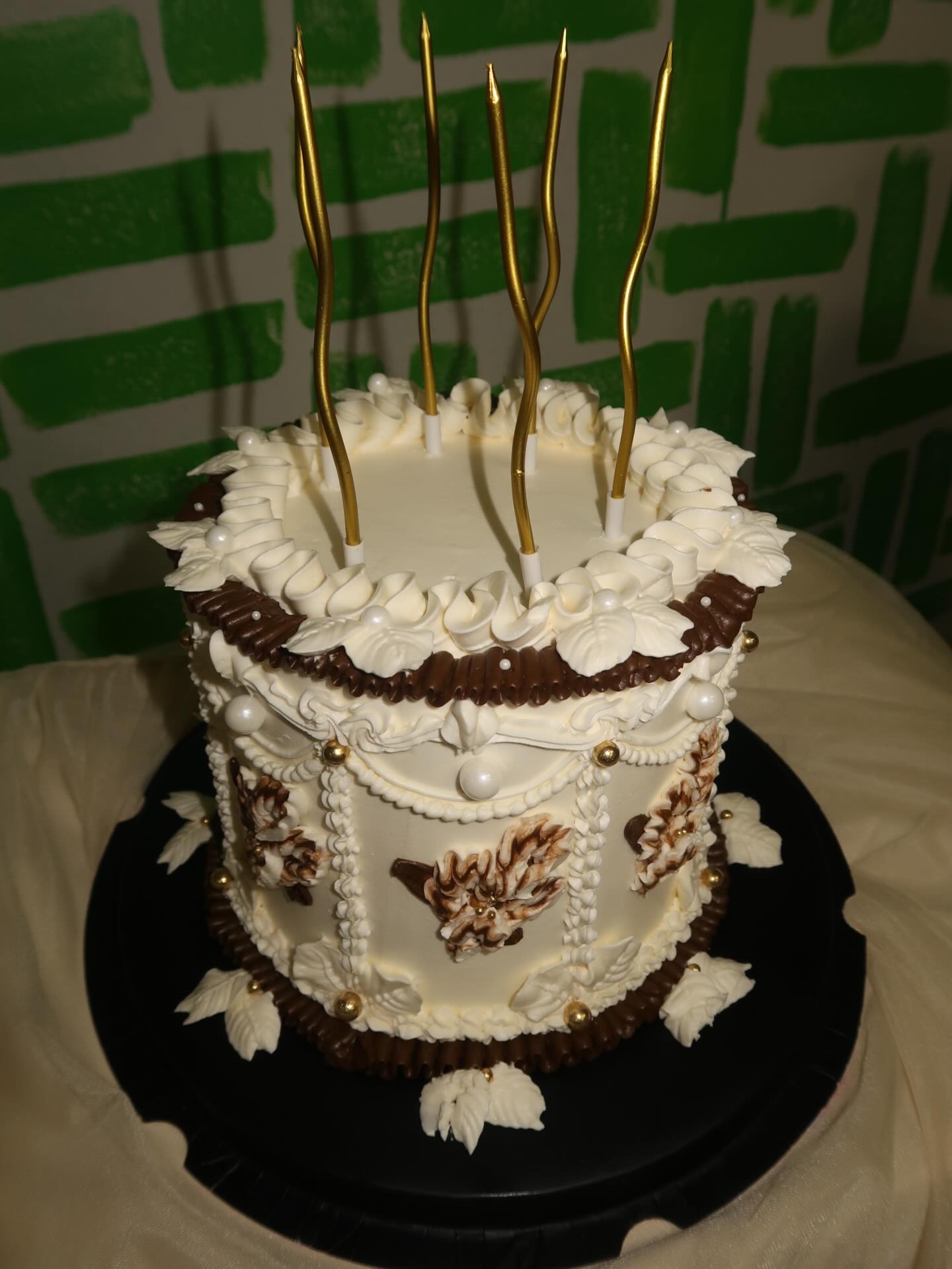 Vintage piped birthday cake with gold candles
